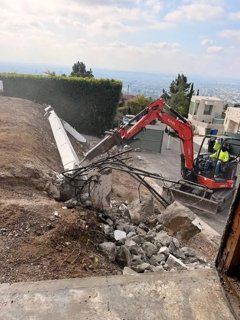 Breaking a concrete retaining wall above the city